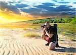 Man photographs the sunset in the desert
