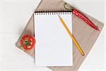 recipe notepad on wooden table with pepper and tomato with pencil