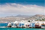 White houses of island Mykonos from the mountains to the sea in sunny weather