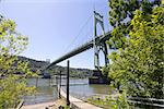 St Johns Bridge with Fishing Boat Dock on Willamette River on a Clear Blue Sky Day