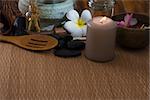 tropical spa setup with frangipani flower hot rocks and massage items