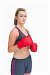 Woman standing and wearing red boxing gloves