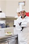 Smiling chef with his salad in the kitchen