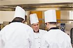 Angry head chef scolding employees in the kitchen