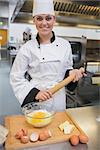 Chef holding rolling pin while making dough in the kitchen