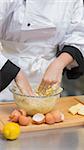 Pastry chef mixing dough with hands