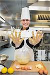 Baker showing her sticky hands while preparing dough