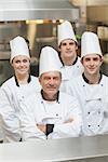 Happy team of Chef's standing in kitchen