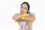 Bored woman leaning on a mop and wearing yellow gloves