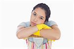 Sad woman leaning on the mop wearing her apron