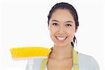 Happy woman with sweeping brush