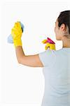 Brunette woman cleaning walls on a white background
