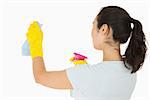 Woman cleaning walls in a white background