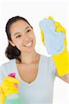 Happy woman cleaning a window on a white background