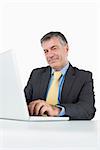 Businessman typing on laptop at his desk