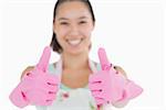Smily woman with gloves and apron and giving thumbs up