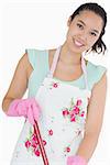 Smiling woman wearing apron with mop