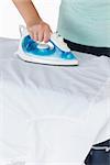 Woman ironing clothes on an ironing table
