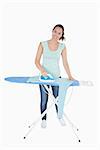 Smiling woman ironing jumper on an ironing table on a white background