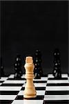 White chess piece standing against black background