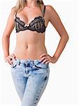 Woman wearing jeans and bra while posing