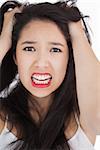 Woman looking shocked and angry against white background