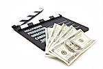 Film slate and money lying against white background