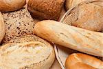 Variety of breads in basket on wooden table