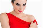 Woman with red dress and red lips looking serious