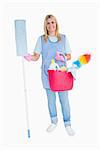 Cheerful maid holding a pink bucket and mop in the white background