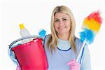 Smiling cleaner woman holding a bucket and feather duster in the white background