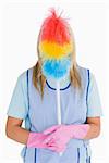Cleaner holding a feather duster in front her face in the white background