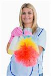 Cleaner holding feather duster in the white background