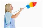 Cleaning woman using a feather duster in the white background