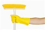 Hand in rubber glove holding sweeping brush