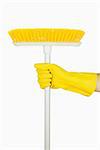 Hand in rubber glove holding broom