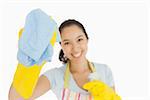 Laughing woman wiping with a blue rag wearing rubber gloves and apron