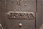 Closeup of an door with Star of David into a steel frame placed on textured colorful old wood.