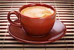 fresh coffee cup on striped bamboo napkin