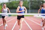 Female athletes close to finish line at track field