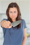 Angry woman holding knife out