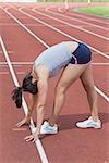 Woman stretching on the running track