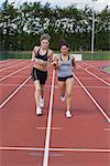 Women trying to win the race on the running track