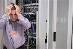 Man looking weary of data servers in data center