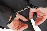 Businessman with handcuffs over white background