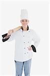 Portrait of happy female chef in unifrom holding rolling pin over white background
