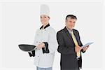 Portrait of businessman holding digital tablet and female chef with frying pan over white background