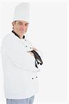 Portrait of smiling chef with arms crossed over white background