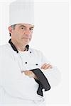 Portrait of confident chef with arms crossed against white background