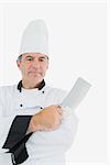 Portrait of confident mature chef holding cleaver over white background